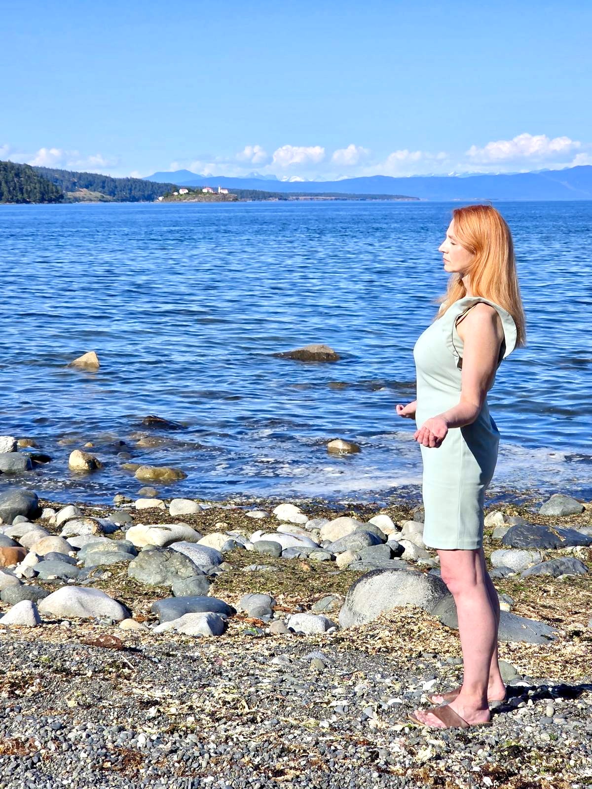 Chantal Normand standing at the shore near Nanaimo, looking out to sea.